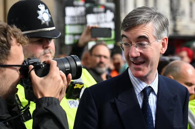 Jacob Rees-Mogg ) looks at a photographer as he arrives to attend the opening day of the annual Conservative Party Conference in Birmingham