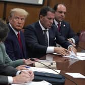 Donald Trump sits with his lawyers during his arraignment at Manhattan Criminal Court on Tuesday (Picture: Timothy A Clary/pool/Getty Images)