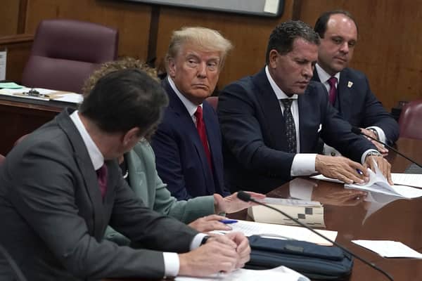 Donald Trump sits with his lawyers during his arraignment at Manhattan Criminal Court on Tuesday (Picture: Timothy A Clary/pool/Getty Images)