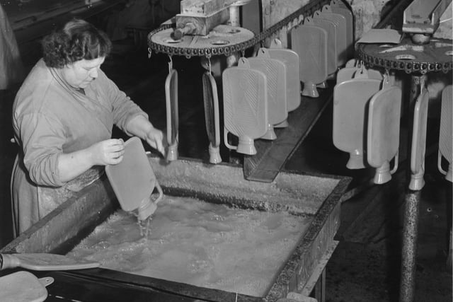Making hot water bottles at the North British Rubber Company in November 1951.