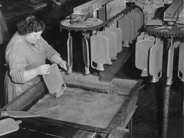 Making hot water bottles at the North British Rubber Company in November 1951.