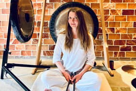 Jo McCoy sitting in front of her gongs