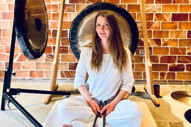 Jo McCoy sitting in front of her gongs