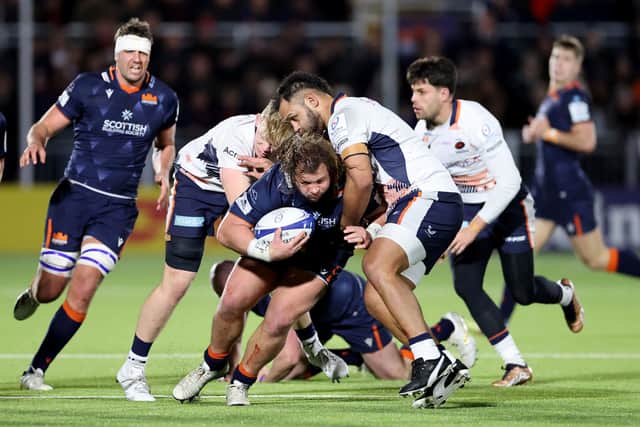 Edinburgh's Pierre Schoeman is tackled by Saracens' Hugh Tizard during the Heineken Champions Cup match at the DAM Health Stadium.