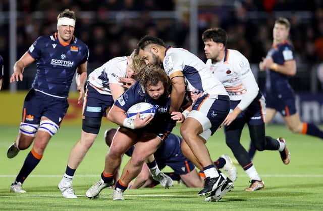 Edinburgh's Pierre Schoeman is tackled by Saracens' Hugh Tizard during the Heineken Champions Cup match at the DAM Health Stadium.