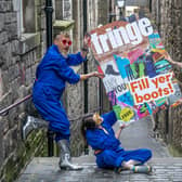 Cris Peploe, Claudia Cawthorne and Martha Haskins pose with a large-scale version of the Edinburgh Festival Fringe 2023 programme cover in the Old Town. Picture: Jane Barlow/PA Wire