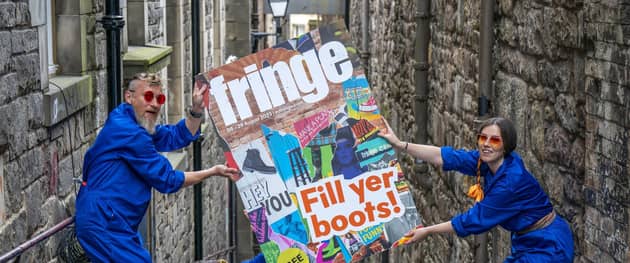 Cris Peploe, Claudia Cawthorne and Martha Haskins pose with a large-scale version of the Edinburgh Festival Fringe 2023 programme cover in the Old Town. Picture: Jane Barlow/PA Wire