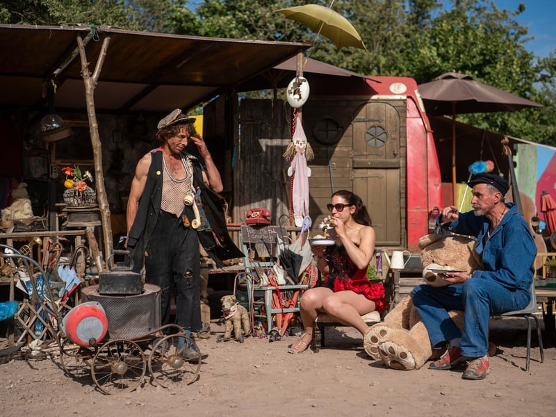People eat food at Rimski's Yard at the Glastonbury Festival at Worthy Farm in Somerset.