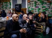 Ukrainians take shelter in a humanitarian aid centre in the besieged town of Bakhmut on Monday (Picture: Dimitar Dilkoff/AFP via Getty Images)