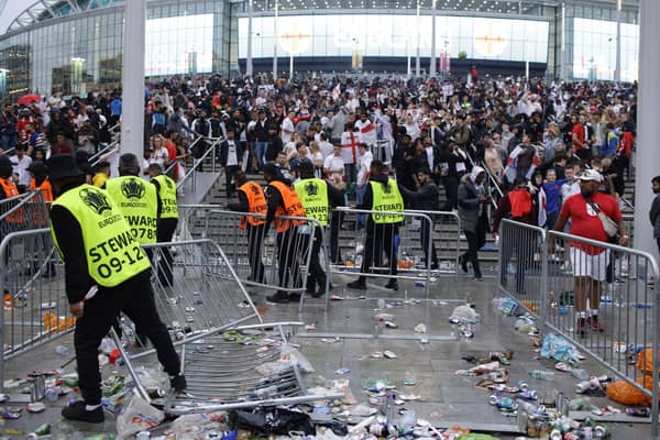 Stewards replace barricades after they were knocked over by supporters outside Wembley on July 11.