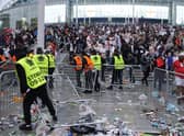 Stewards replace barricades after they were knocked over by supporters outside Wembley on July 11.