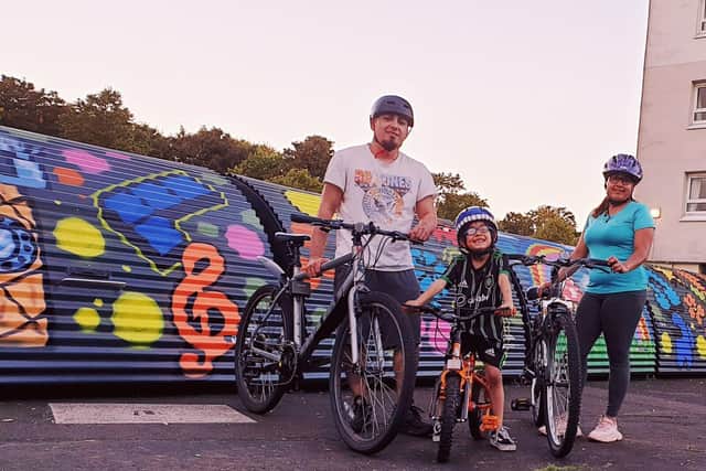 Christian Lopez and his family prepare for a bike ride at their home in north-west Glasgow. Through
