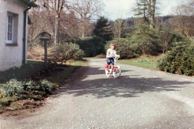 Rebecca Smith riding her bike at South Lodge, one of the tied housing set ups she lived in growing up (Rebecca Smith)