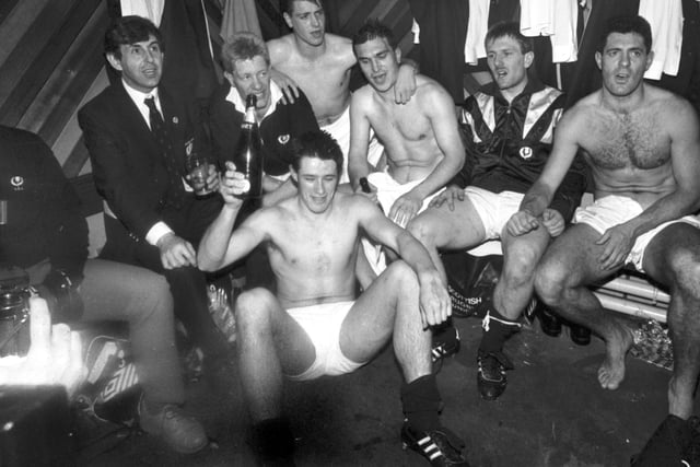Some of the Scotland rugby squad singing in the changing rooms at Murrayfield after their win over England. Team manager Ian McGeechan joins in (left) as Tony Stanger bags the bottle of champagne.