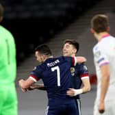 John McGinn of Scotland celebrates with team mate Kieran Tierney after scoring their side's first goal during the FIFA World Cup 2022 Qatar qualifying match between Scotland and Faroe Islands at Hampden Park on March 31, 2021 in Glasgow, Scotland. (Photo by Ian MacNicol/Getty Images)