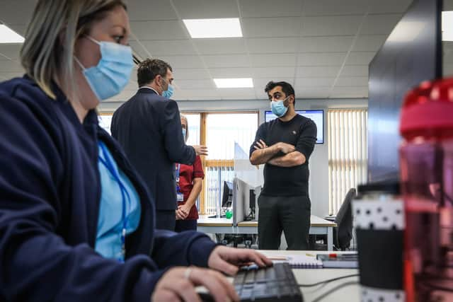 Health secretary Humza Yousaf (right) speaks to Jim Miller, chief executive of NHS 24. Picture: PA