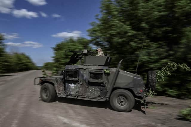 Ukrainian servicemen move toward the frontline at a checkpoint near the city of Lysychansk in the eastern Ukranian region of Donbas, on May 23, 2022, amid Russian invasion of Ukraine. (Photo by ARIS MESSINIS / AFP) (Photo by ARIS MESSINIS/AFP via Getty Images)