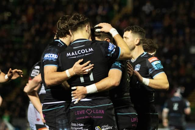 Glasgow Warriors' Facundo Cordero celebrates with Jamie Dobie (No 11) after scoring a second-half try against Dragons.