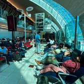 Passengers wait for their flights at the Dubai International Airport in Dubai on Wednesday. Dubai's major international airport diverted and cancelled scores of incoming flights as heavy rains lashed the United Arab Emirates, causing widespread flooding around the desert country