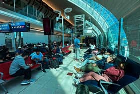 Passengers wait for their flights at the Dubai International Airport in Dubai on Wednesday. Dubai's major international airport diverted and cancelled scores of incoming flights as heavy rains lashed the United Arab Emirates, causing widespread flooding around the desert country