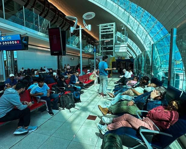 Passengers wait for their flights at the Dubai International Airport in Dubai on Wednesday. Dubai's major international airport diverted and cancelled scores of incoming flights as heavy rains lashed the United Arab Emirates, causing widespread flooding around the desert country