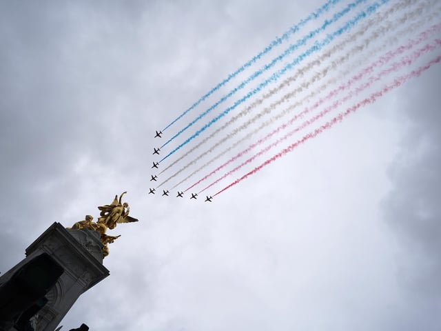 A general view of flypast by aircraft from the Red Arrows over the Mall following the coronation of King Charles III and Queen Camilla in London