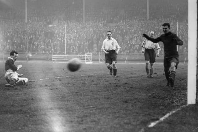 Scottish footballer Hughie Gallacher tries for a goal during the international match between England and Scotland on March 31, 1928. (Photo by Davis/Topical Press Agency/Getty Images)