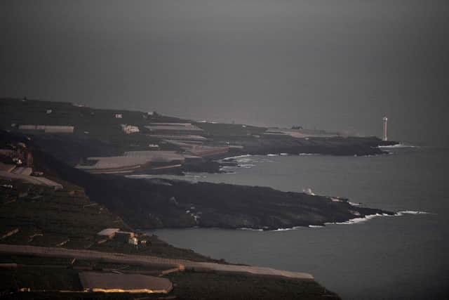 The lava flow produced by the Cumbre Vieja volcano falls into the Atlantic Ocean, as seen from Tijarafe, in the Canary Island of La Palma on October 10, 2021. (Image credit: Jorge Guerrero/AFP)