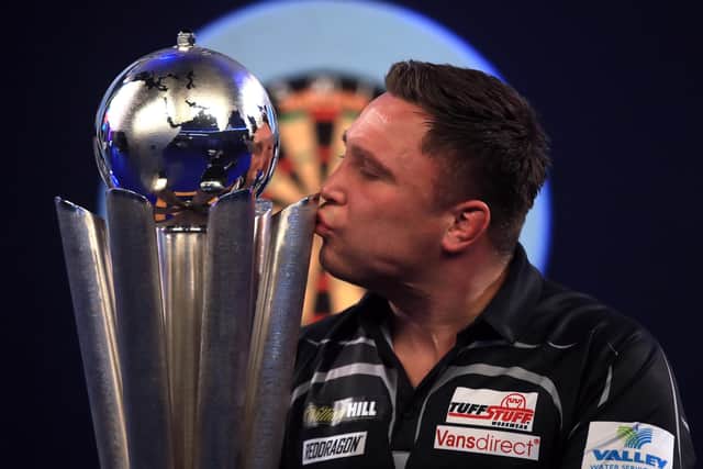 Gerwyn Price kisses the trophy after winning the William Hill World Darts Championship at Alexandra Palace, London.