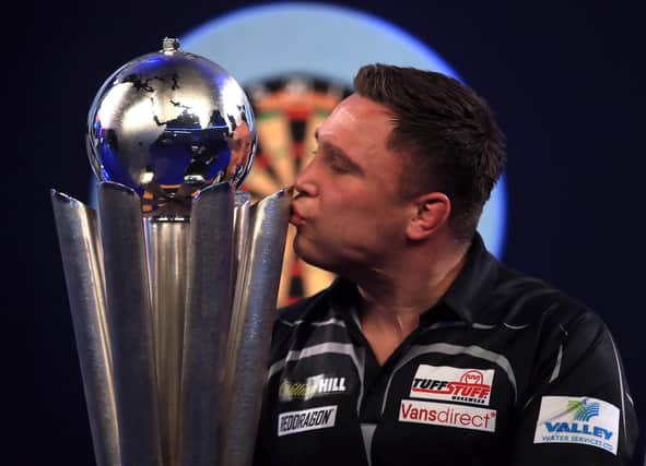 Gerwyn Price kisses the trophy after winning the William Hill World Darts Championship at Alexandra Palace, London.