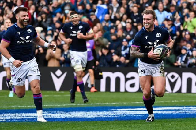 Ali Price, left, is all smiles as Stuart Hogg makes Scottish rugby history with his try against Japan.  (Photo by Paul Devlin / SNS Group)