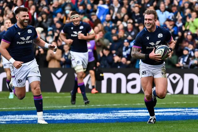 Ali Price, left, is all smiles as Stuart Hogg makes Scottish rugby history with his try against Japan. (Photo by Paul Devlin / SNS Group)