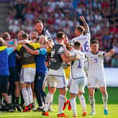 Scotland players and staff celebrate the momentous win over Norway in Oslo. (Photo by HEIKO JUNGE/NTB/AFP via Getty Images)