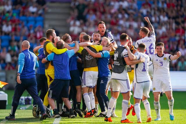 Scotland players and staff celebrate the momentous win over Norway in Oslo. (Photo by HEIKO JUNGE/NTB/AFP via Getty Images)