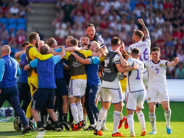 Scotland players and staff celebrate the momentous win over Norway in Oslo. (Photo by HEIKO JUNGE/NTB/AFP via Getty Images)