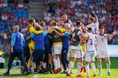 Scotland players and staff celebrate the momentous win over Norway in Oslo. (Photo by HEIKO JUNGE/NTB/AFP via Getty Images)