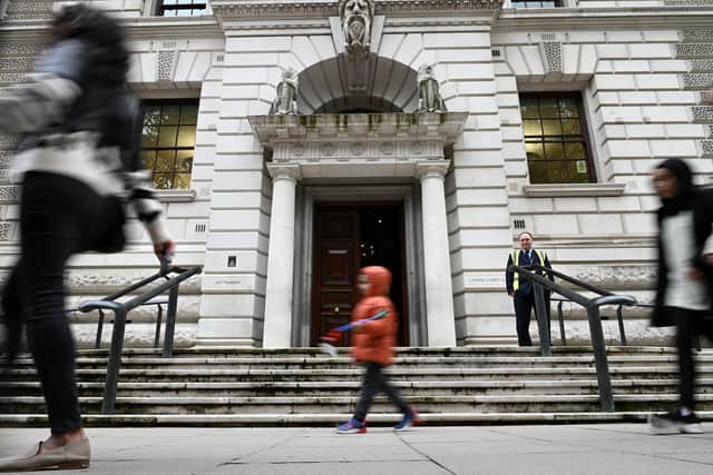 Pedestrians walk outside the Treasury building in central London. Picture: Daniel Leal-Olivas/AFP via Getty Images