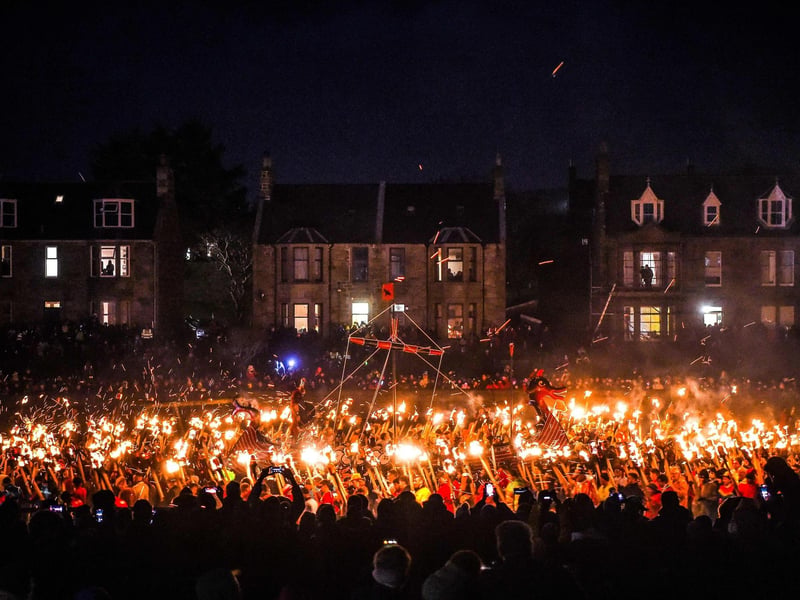 Participants take part in the Up Helly Aa festival parade through the streets of Lerwick, Shetland Islands on January 31, 2023. - Up Helly Aa celebrates the influence of the Scandinavian Vikings in the Shetland Islands and culminates with up to 1,000 'guizers' (men in costume) throwing flaming torches into their Viking longboat and setting it alight later in the evening. Photo by Andy Buchanan / AFP