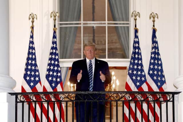 President Donald Trump gives a thumbs up upon return to the White House from Walter Reed National Military Medical Center on October 05, 2020 in Washington, DC.