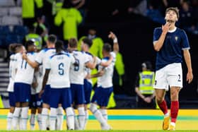 Scotland defender Aaron Hickey looks to the heavens as England celebrate at Hampden.