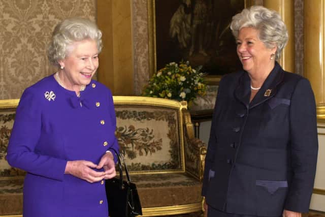 Sharing a joke with Queen Elizabeth II in 2000 (Picture: PA)