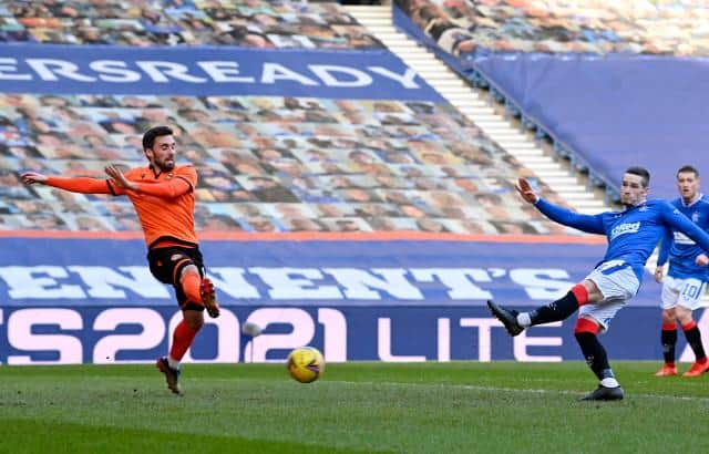 Ryan Kent makes it 2-0 to Rangers as his shot is deflected in off Dundee United defender Ryan Edwards. (Photo by Rob Casey / SNS Group)