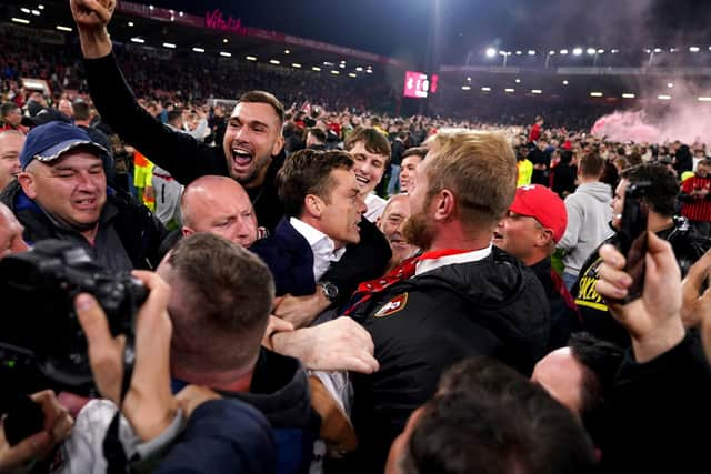 Bournemouth manager Scott Parker (centre) celebrates winning promotion to the Premier League.