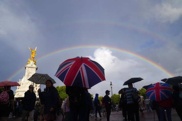 A rainbow is seen, as members of the public gather outside Buckingham Palace in central London. Queen Elizabeth II is under medical supervision with the royal family rushing to be by her side amid serious health fears. Buckingham Palace has issued a statement saying royal doctors were concerned for the Queen's health, as the Prince of Wales and her other children, and the Duke of Cambridge cleared their diaries and immediately headed to her home in the Scottish Highlands.