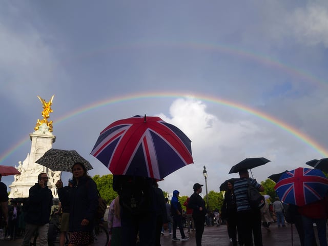A rainbow is seen, as members of the public gather outside Buckingham Palace in central London. Queen Elizabeth II is under medical supervision with the royal family rushing to be by her side amid serious health fears. Buckingham Palace has issued a statement saying royal doctors were concerned for the Queen's health, as the Prince of Wales and her other children, and the Duke of Cambridge cleared their diaries and immediately headed to her home in the Scottish Highlands.