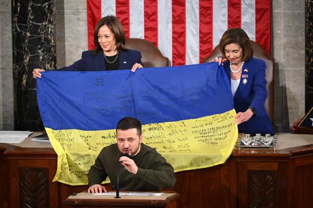 Volodymyr Zelensky gave a Ukrainian national flag signed by soldiers on the frontline to US House Speaker Nancy Pelosi and US Vice President Kamala Harris (Picture: Mandel Ngan/AFP via Getty Images)