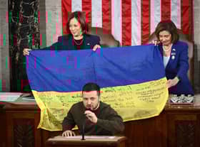 Volodymyr Zelensky gave a Ukrainian national flag signed by soldiers on the frontline to US House Speaker Nancy Pelosi and US Vice President Kamala Harris (Picture: Mandel Ngan/AFP via Getty Images)