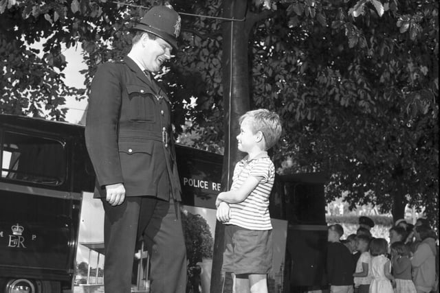 In the 1960s the police would hold regular recruitment drives on Princes Street and in Princes Street Gardens. Little Angus McPherson is pictured talking to a London Metropolitan Police officer at such an event.
