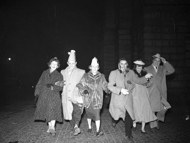 Hogmanay scene at the Tron Church as six Americans dance down the High Street.