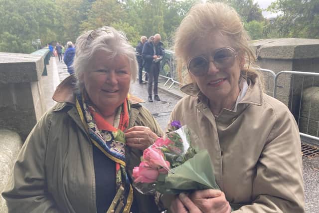 Friends Jo Phelan and Val Morrison, from Inverurie, arrive at Balmoral to lay flowers for The Queen.